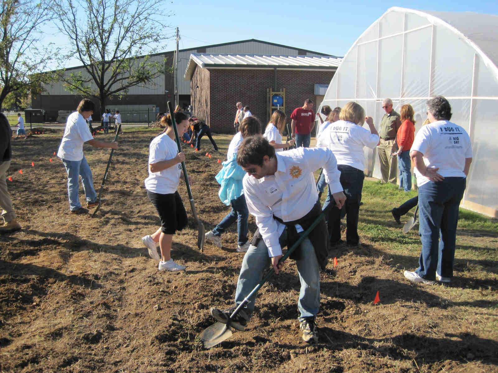 Jacob Holloway a member of MAREH helps students establish their sustainable garden plots at Harrisburg Middle School. 