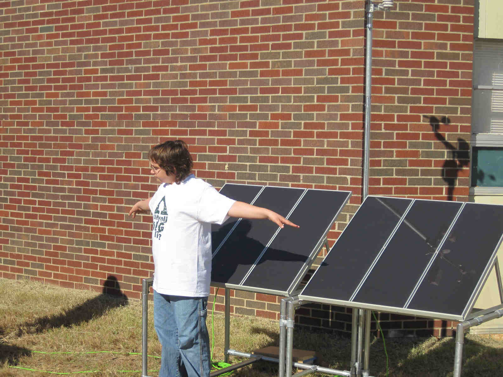 Let the experiments begin.  A student demonstrates the variation of energy production of the solar panels is directly related to the amount of sunlight that strikes them.