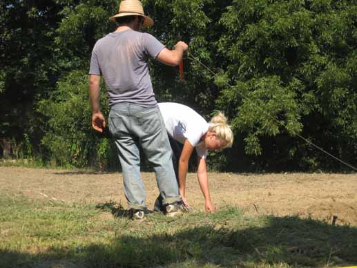 Jacob Holloway learns how to stake-out plots from Jill Zartman of FoodCorps.